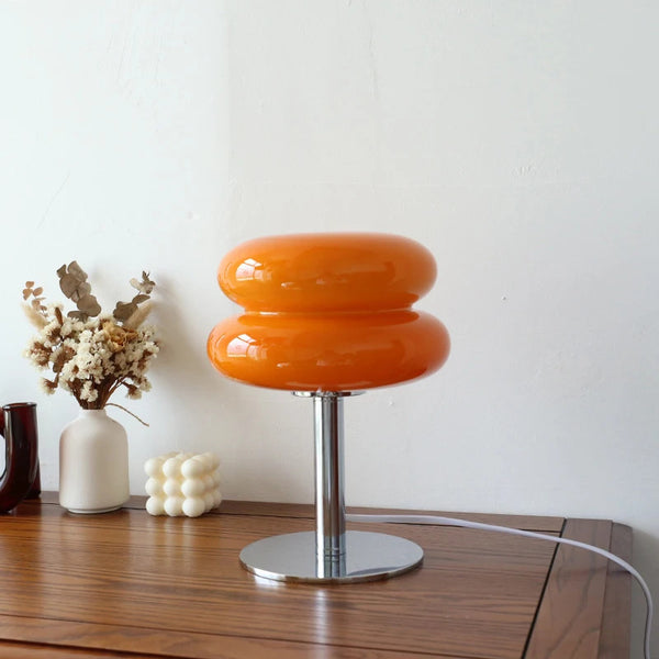Stylish retro orange macaron style lamp on display on table